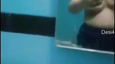 Desi sweet thing touches soft natural breasts in front of a mirror